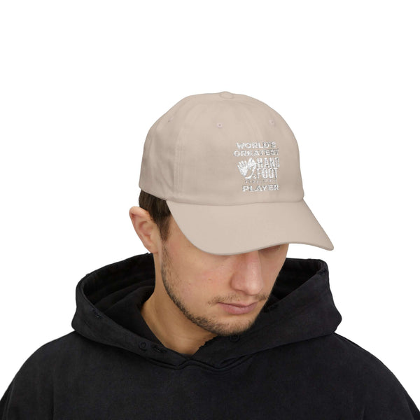 Man wearing World's Greatest Player Classic Dad Cap in beige, adding casual style to black hoodie outfit.
