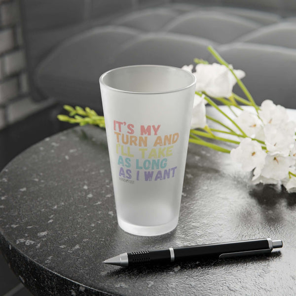 It's My Turn 16 oz Frosted Pint Glass on table with flowers, ideal for gifts or gatherings. Fun design enhances drinkware collections.