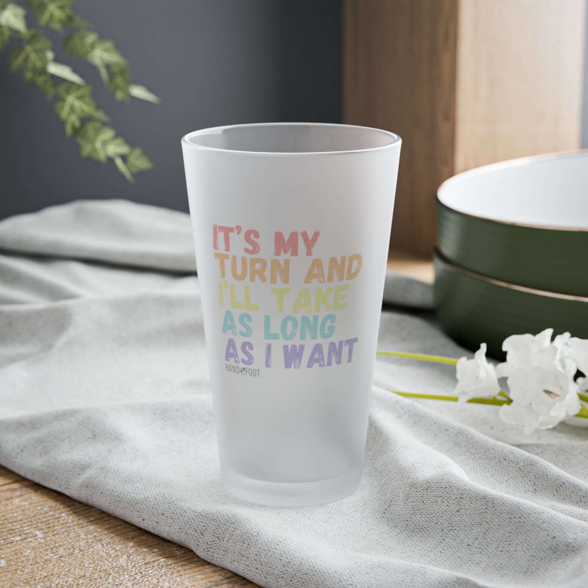 It's My Turn 16 oz Frosted Pint Glass with colorful text design on a table setting, ideal for gatherings and as a fun gift.