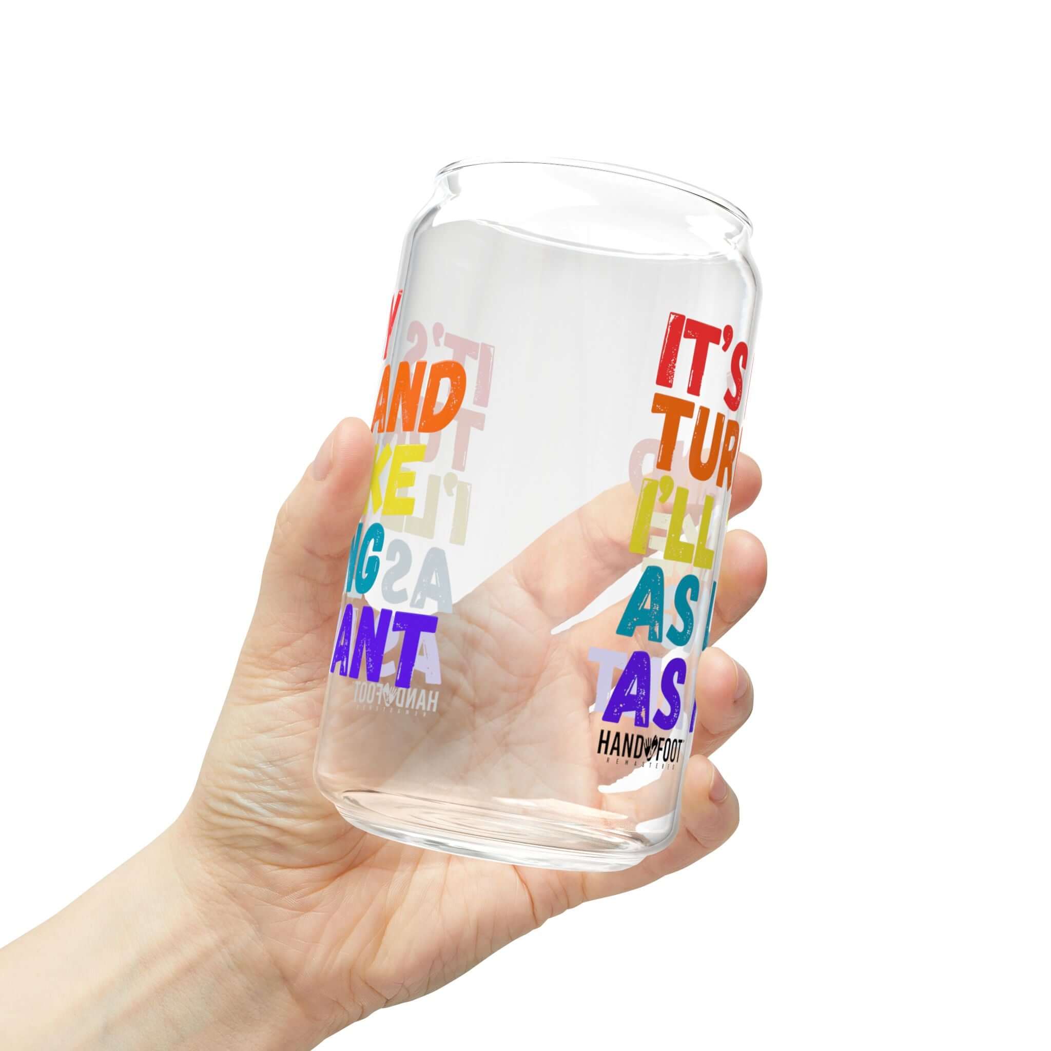 Hand holding a 16oz It's My Turn Sipper Glass with colorful text, adding vibrant style to your hydration routine.