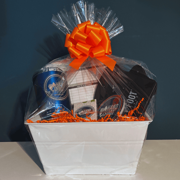 Limited-Edition Hand & Foot Remastered Accessory Set gift basket wrapped with bright orange bow, perfect for game enthusiasts.