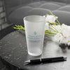 Tears of the People I Beat 16 oz Frosted Pint Glass on table with flowers and pen