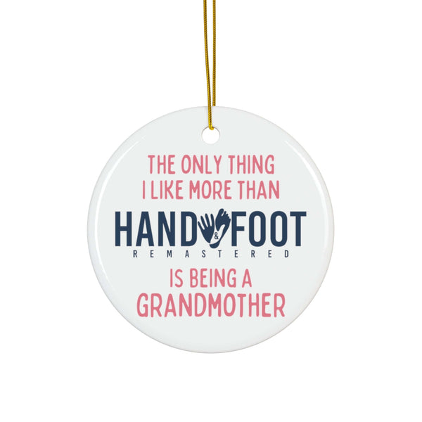 Round ceramic ornament with gold thread, featuring text: 'The only thing I like more than Hand & Foot is being a grandmother'.