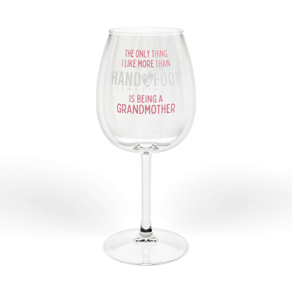 Being a Grandmother Hand & Foot wine glass with pink text, 12 oz capacity, elegant and glossy finish for game nights and wine lovers.
