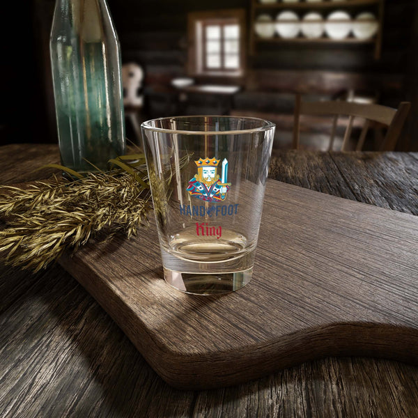 Hand & Foot King Shot Glass on wooden table, vibrant design adds cheer to barware, ideal for parties or gatherings.